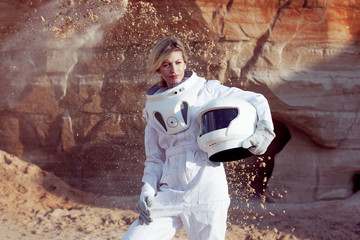 Wall Mural - futuristic astronaut without a helmet on another planet, image with the effect of toning