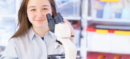 Sticker - Teen girl in laboratory classes, banner horizontal format with free copyspace