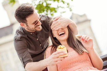 man surprising a woman with a gift