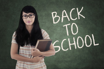 Wall Mural - Girl with book and text Back to School