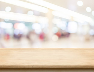 Empty wood table top with office building hall way blur backgrou