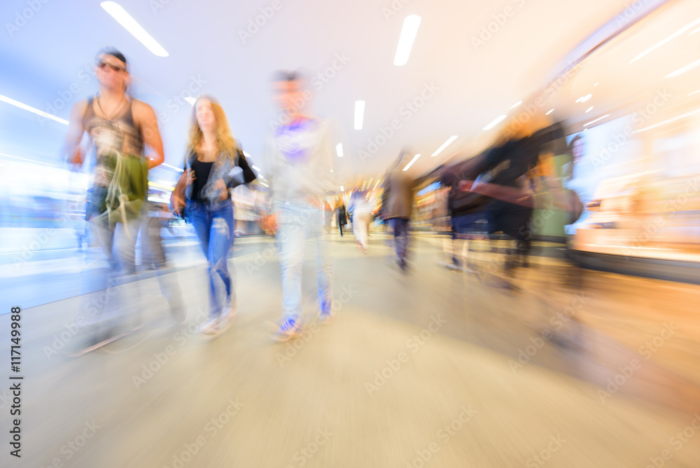 Zoom and motion blurred crowd walking in city. Effect made in camera ...