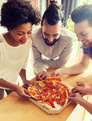 Canvas Print - happy business team eating pizza in office