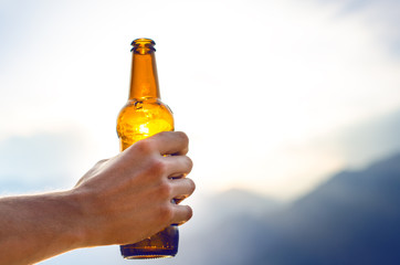 Bottle of beer. Natural background. Man hand´s keep a bottle of beer. Alcohol drink.