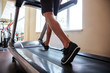 © Drobot Dean - Legs of young fitness man running on treadmill in gym