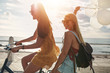 © Jacob Lund - Happy young women on bike together with balloons