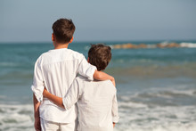 Portrait Of Happy Brothers In White Shirts On Background Of Sea