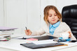 © Cookie Studio - Young beautiful girl sitting at working place in office.