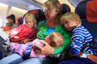 © nadezhda1906 - mother with newborn baby, little son and daughter travel by plane