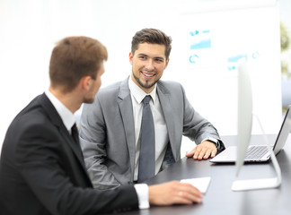 Poster - Image of two young businessmen discussing project at meeting