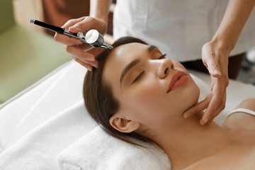 facial beauty treatment. woman getting oxygen skin peeling