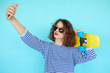 © kegfire - Pretty cool young woman in sunglasses with skateboard