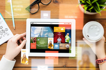 Poster - close up of woman with tablet pc on wooden table