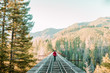 © Ryan Longnecker - Man walking on elevated train tracks