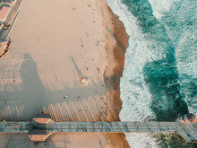 Overhead View Of Pier And Ocean With Sandy Beach