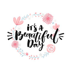 Wall Mural - It's a beautiful day. Brush lettering in floral wreath. Inspirational quote, modern calligraphy