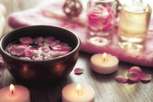 Petals In Bowl With Candles On Wooden Background