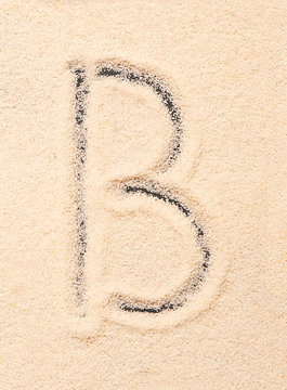B letter written on sand