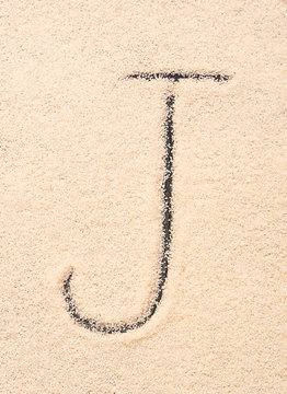 J letter written on sand