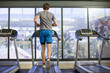 © onoky - Back view of a man running on a treadmill