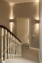 Staircase With Wooden Spindles And Corner Mounted Up-down Lighters