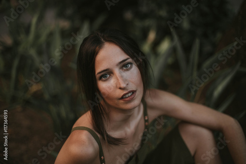 Plakát Sensual brunette woman in khaki looking at camera