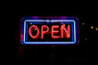 neon OPEN sign welcomes customers