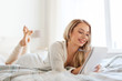 © Syda Productions - happy young woman with notebook in bed at home