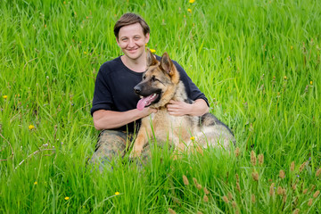 Happy Owner hugs his dog. German shepherd Training