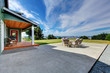 © Iriana Shiyan - VIew of large concrete floor patio area with table set at backyard