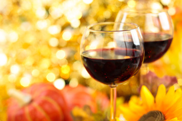 Autumn arrangement with wine, sunflowers and pumpkins.