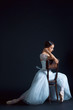 © master1305 - Portrait of the classical ballerina in white dress on black background