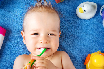 Wall Mural - Baby lying on towel with washing tools