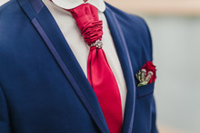 Grooms With Red Tie And Red Rose Boutonniere On Wedding Day