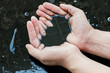 © zoneteen - crude oil in hand due to crude oil leak.crude oil spill concept.
