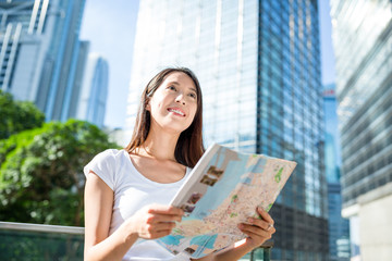 Wall Mural - Woman looking at city map in Hong Kong city