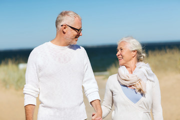 Poster - happy senior couple holding hands on summer beach