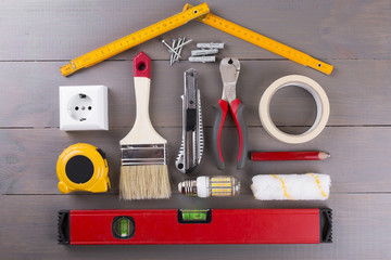 DIY construction tools on wooden background