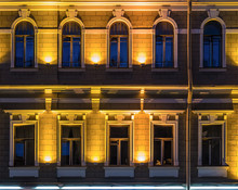Several Windows In A Row On Night Illuminated Facade Of Urban Office Building Front View, St. Petersburg, Russia.