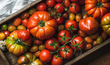 Colorful Tomatoes Of Different Sizes And Kinds In Dark Wooden Tray, Top View, Horizontal Composition