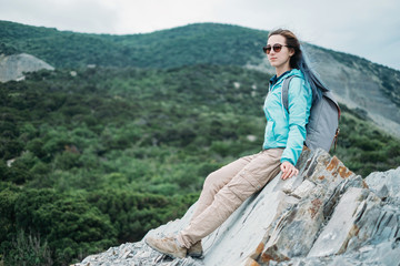 Poster - Hiker girl resting on rocks