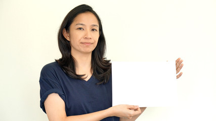 Wall Mural - South East Asian girl casually holding while sign for copy space