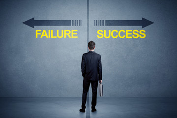 Businessman standing in front of success and failure arrow conce