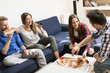 © BGStock72 - Friends eating pizza in th room