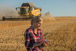 © eric - female farmer and combine harvester