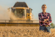 © eric - female farmer and combine harvester
