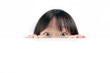 Little Asian girl peeping over white background.