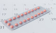 Close up birth-control pill with date of calendar background, health care and medicine concept