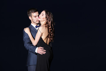 Wall Mural - Elegant couple on dark background