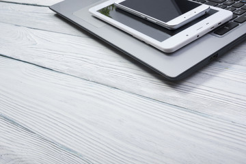 set of modern computer devices - laptop, tablet and phone close up